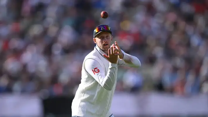 Joe Root catches a cricket ball