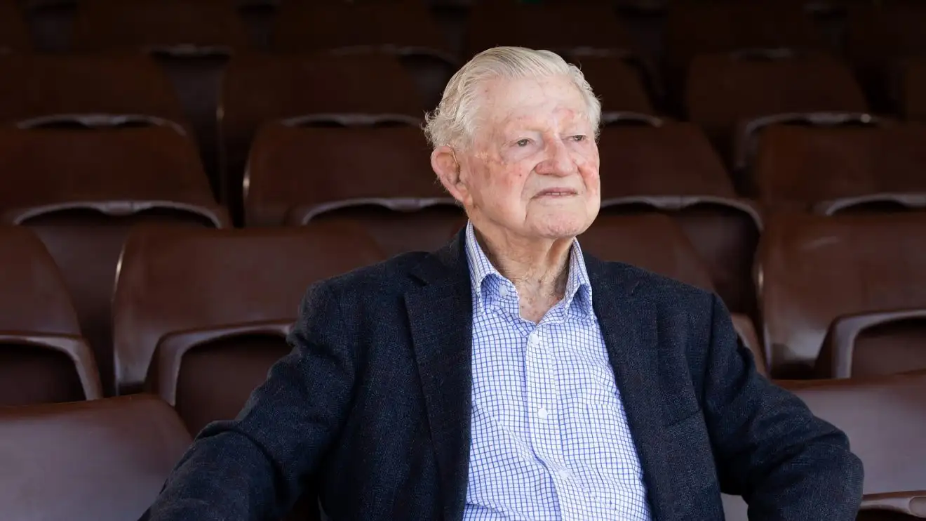 Neil Harvey sits