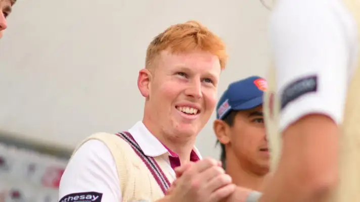 James Rew smiles