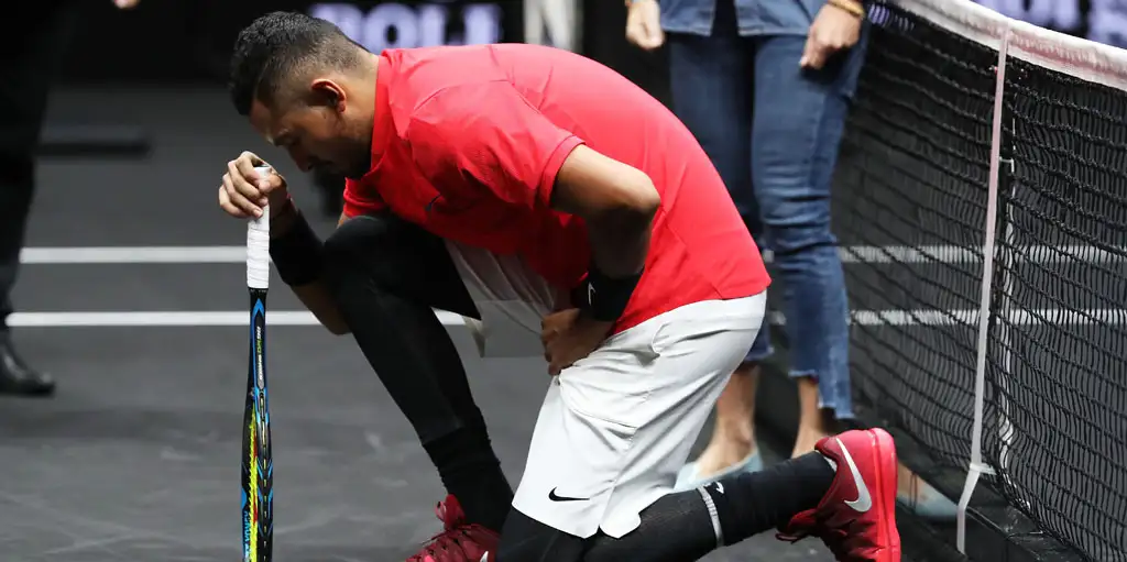 Nick Kyrgios kneeling