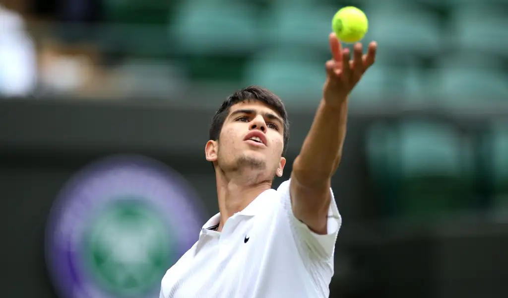 Carlos Alcaraz tosses the ball