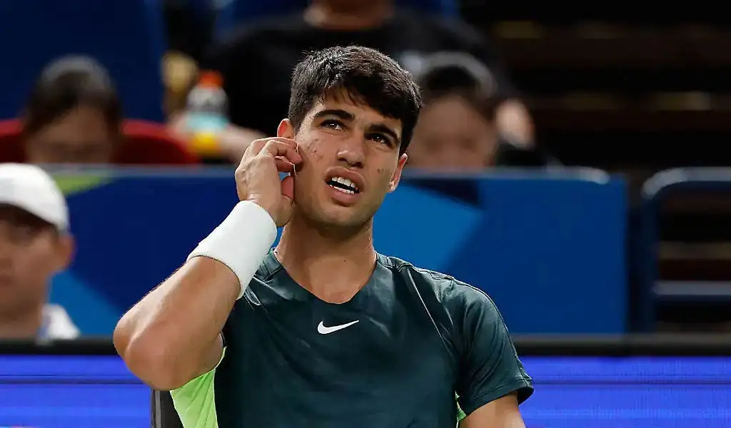 Carlos Alcaraz looks up during his match