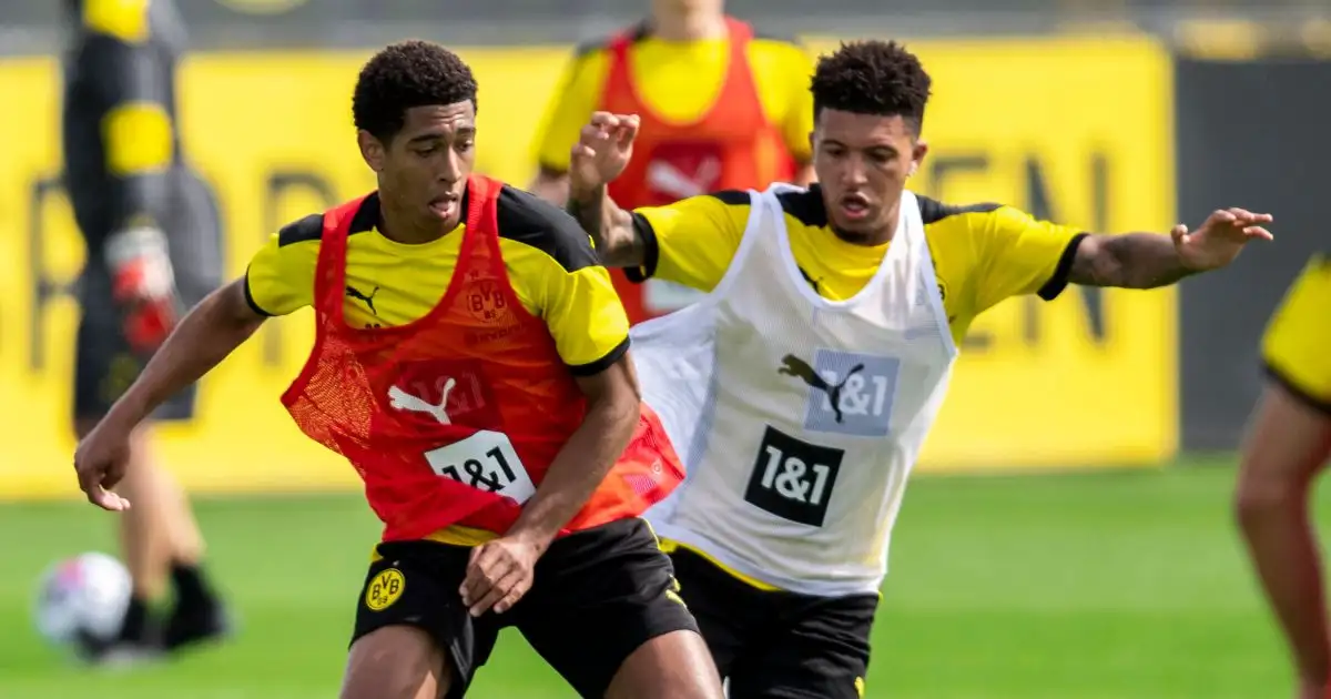 Jude Bellingham and Jadon Sancho compete for the ball