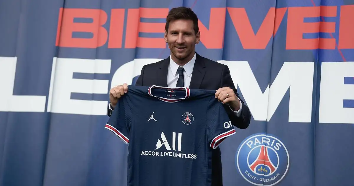 Lionel Messi holds up PSG shirt