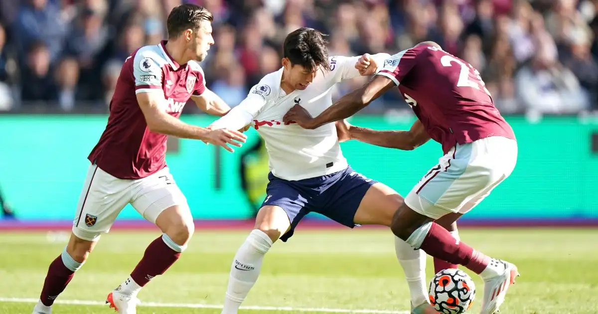 Spurs forward Son Heung-min tries to beat two players