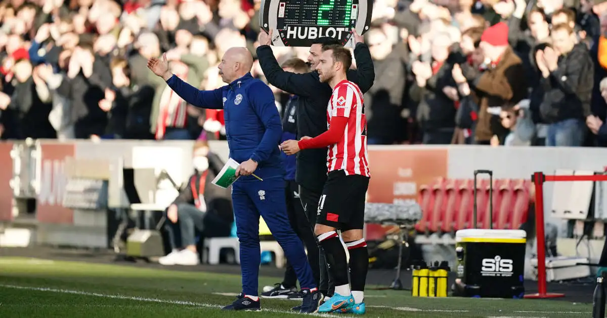 Brentford's Christian Eriksen poses with fans in the stands after