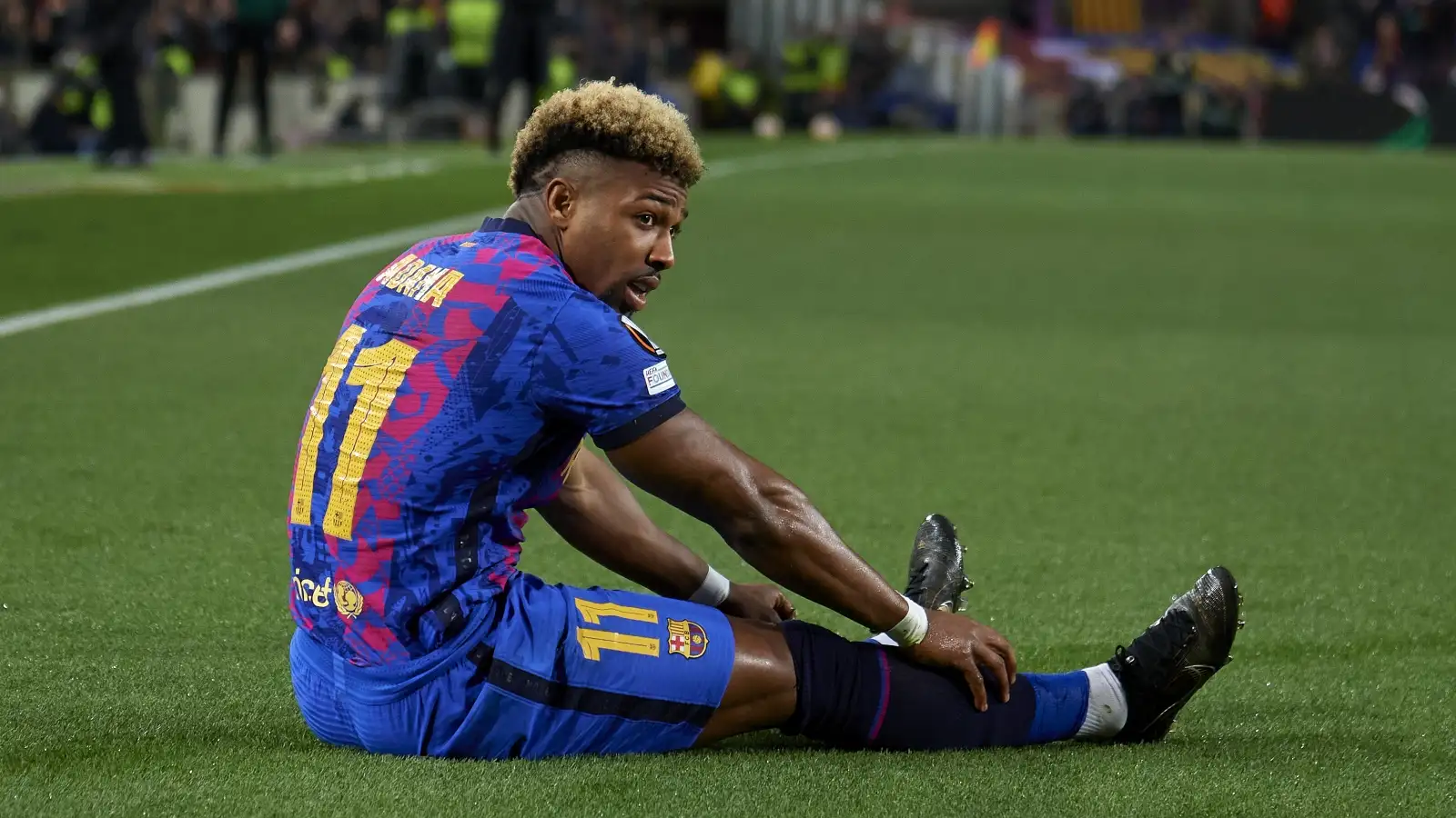 Barcelona winger Adama Traore lies injured on the pitch