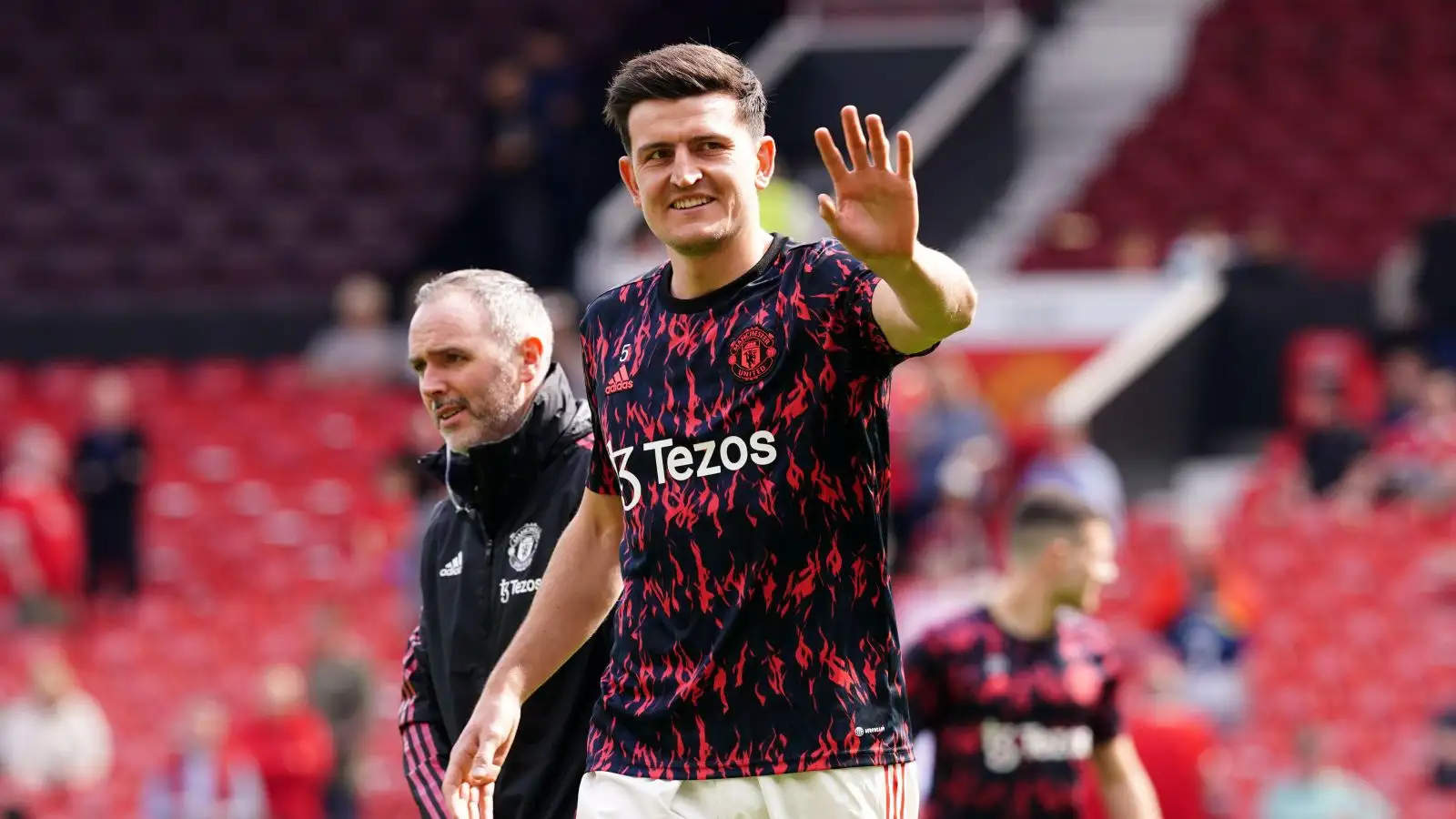 Man Utd captain Harry Maguire waves to someone in the crowd