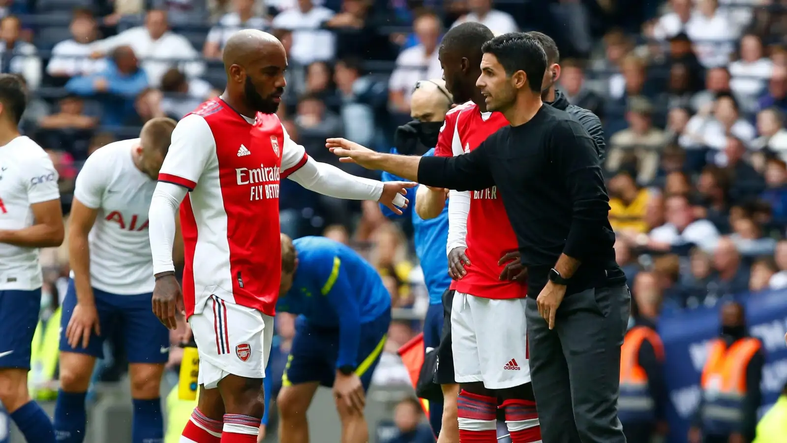 Mikel Arteta and Alexandre Lacazette speaking on the touchline