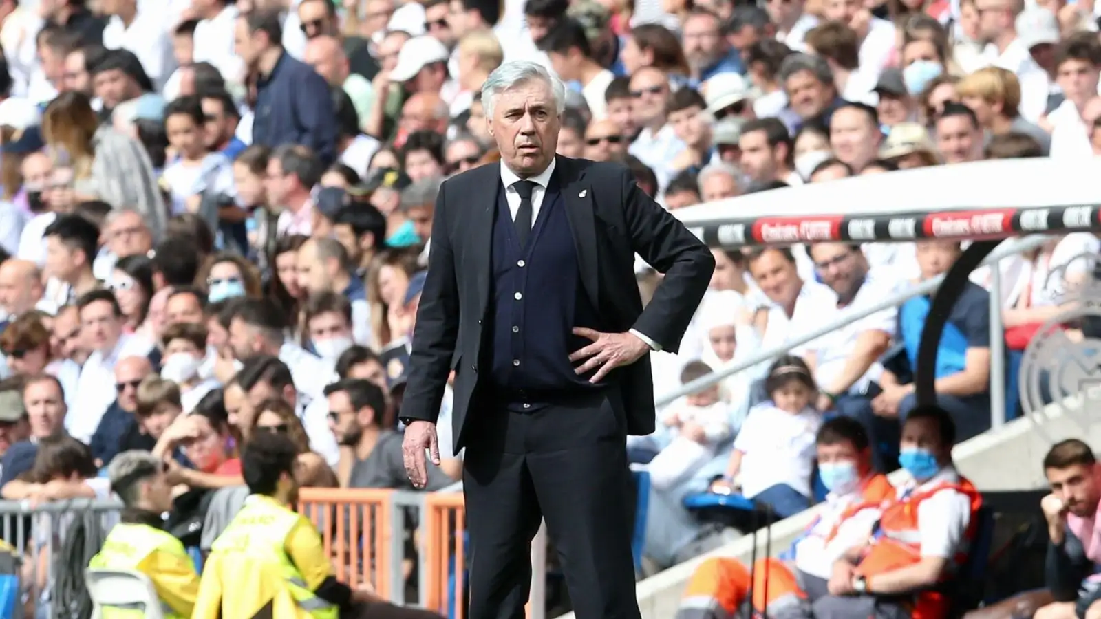 Carlo Ancelotti stands with his hand on his hip