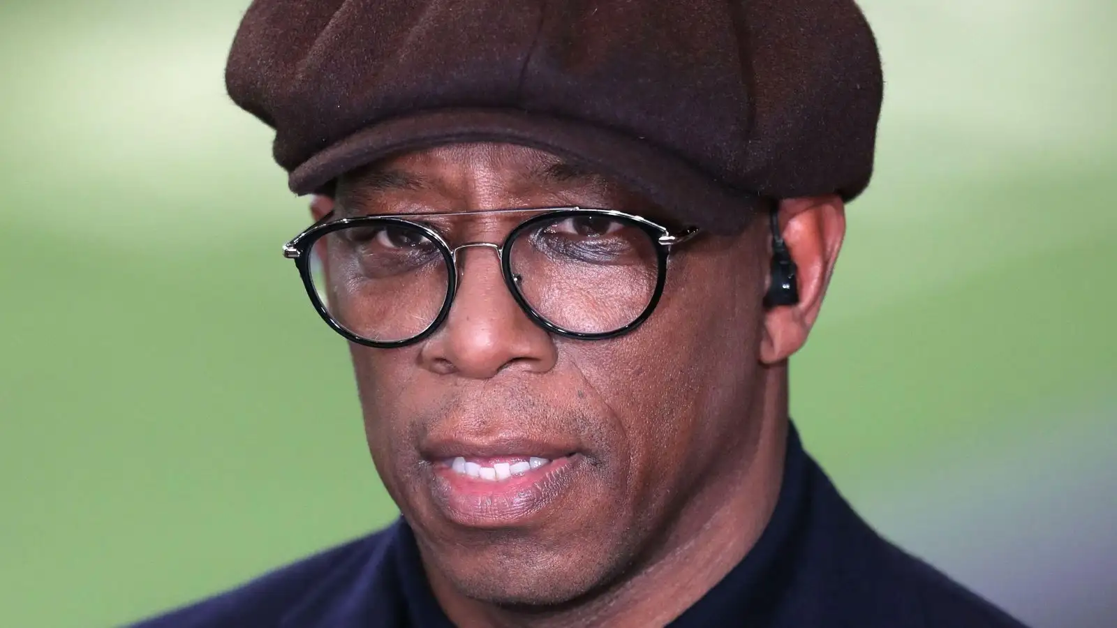 Arsenal legend Ian Wright watches a clip