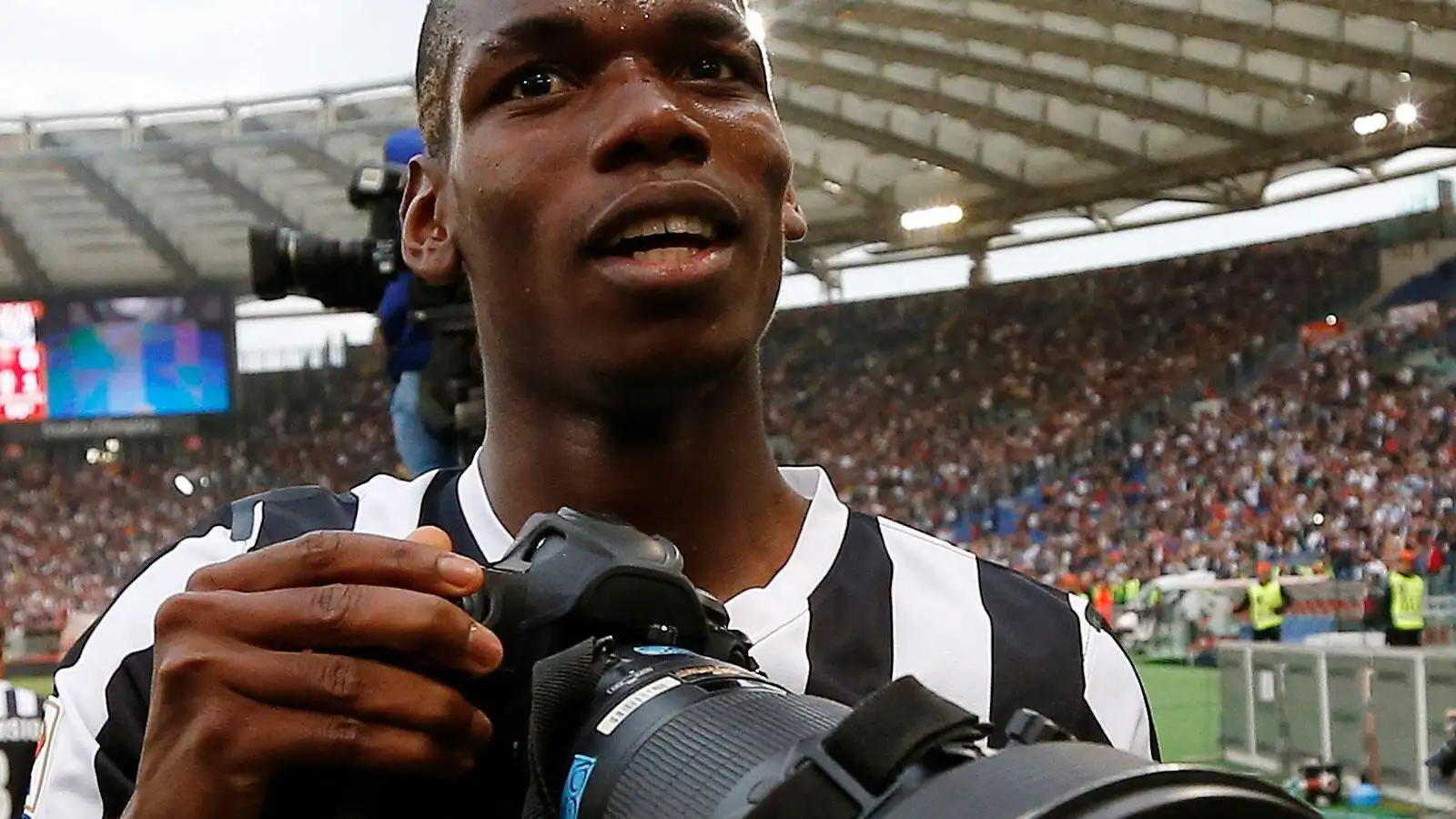 Paul Pogba takes a camera during his Juventus career.