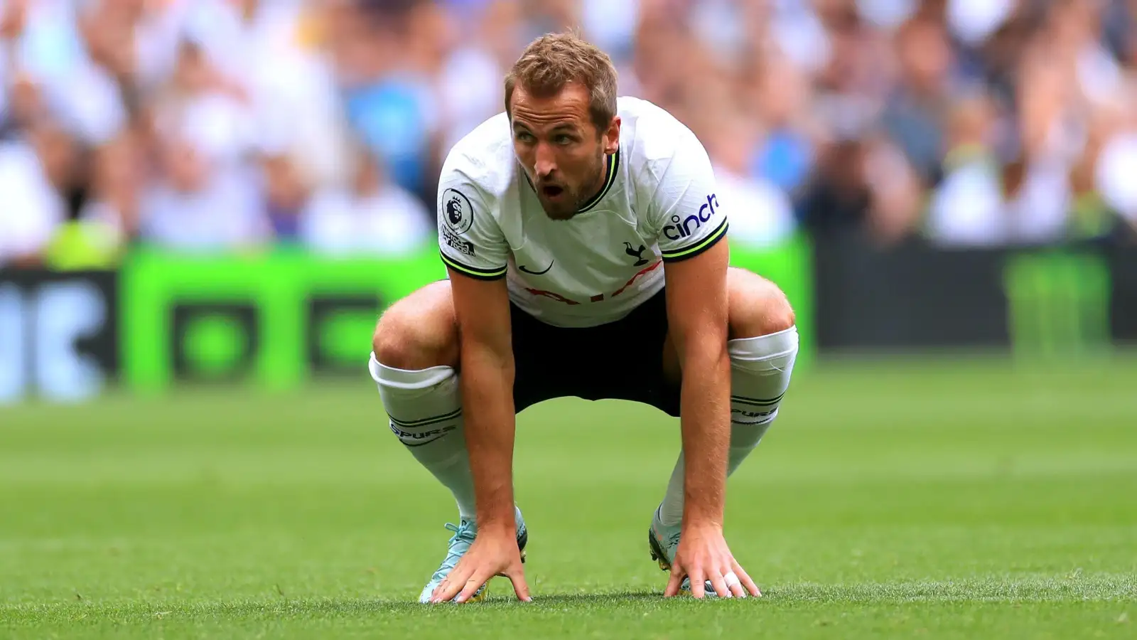 Tottenham striker Harry Kane squats during a match against Fulham