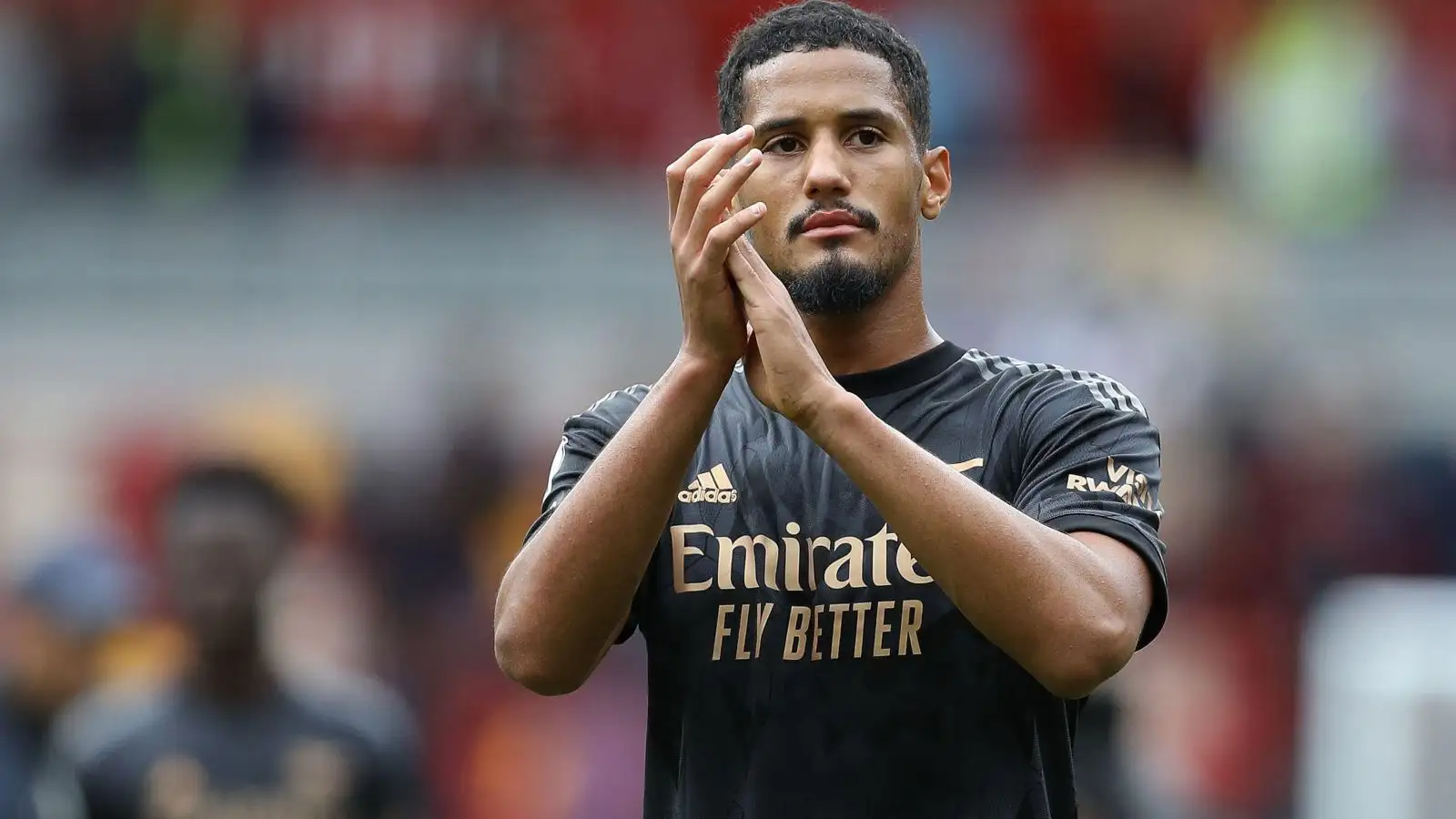 Arsenal defender William Saliba claps the supporters