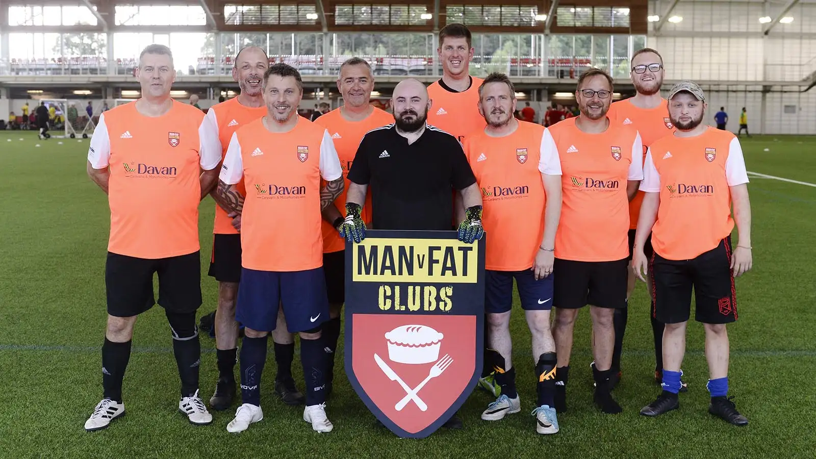 Team post for photo at MAN v FAT Football National Finals, 2021