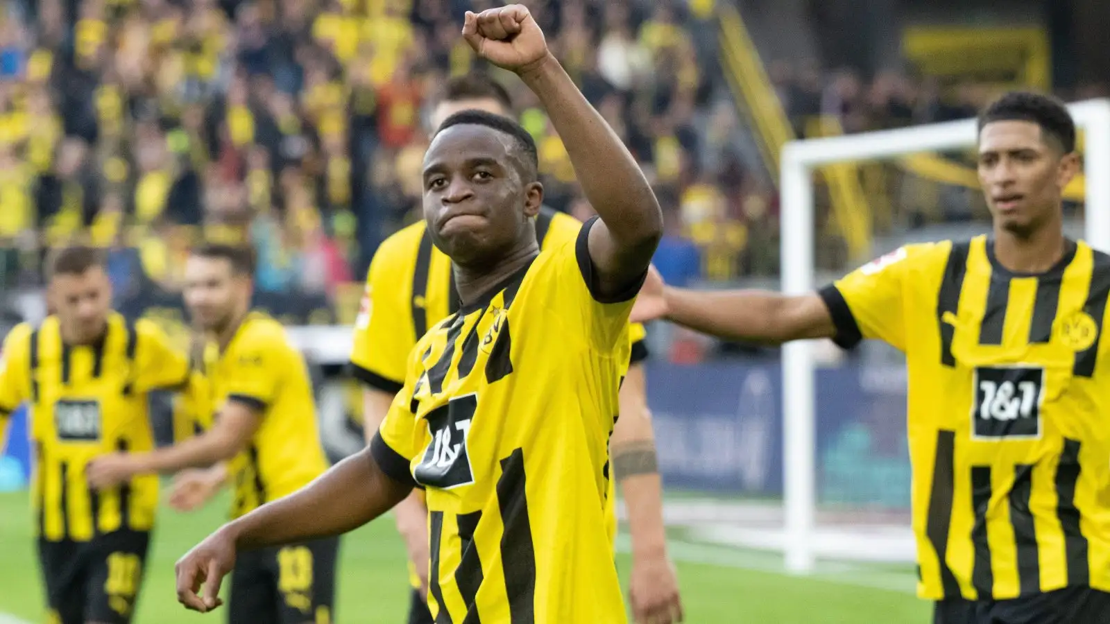 Youssoufa Moukoko celebrates scoring for Borussia Dortmund.