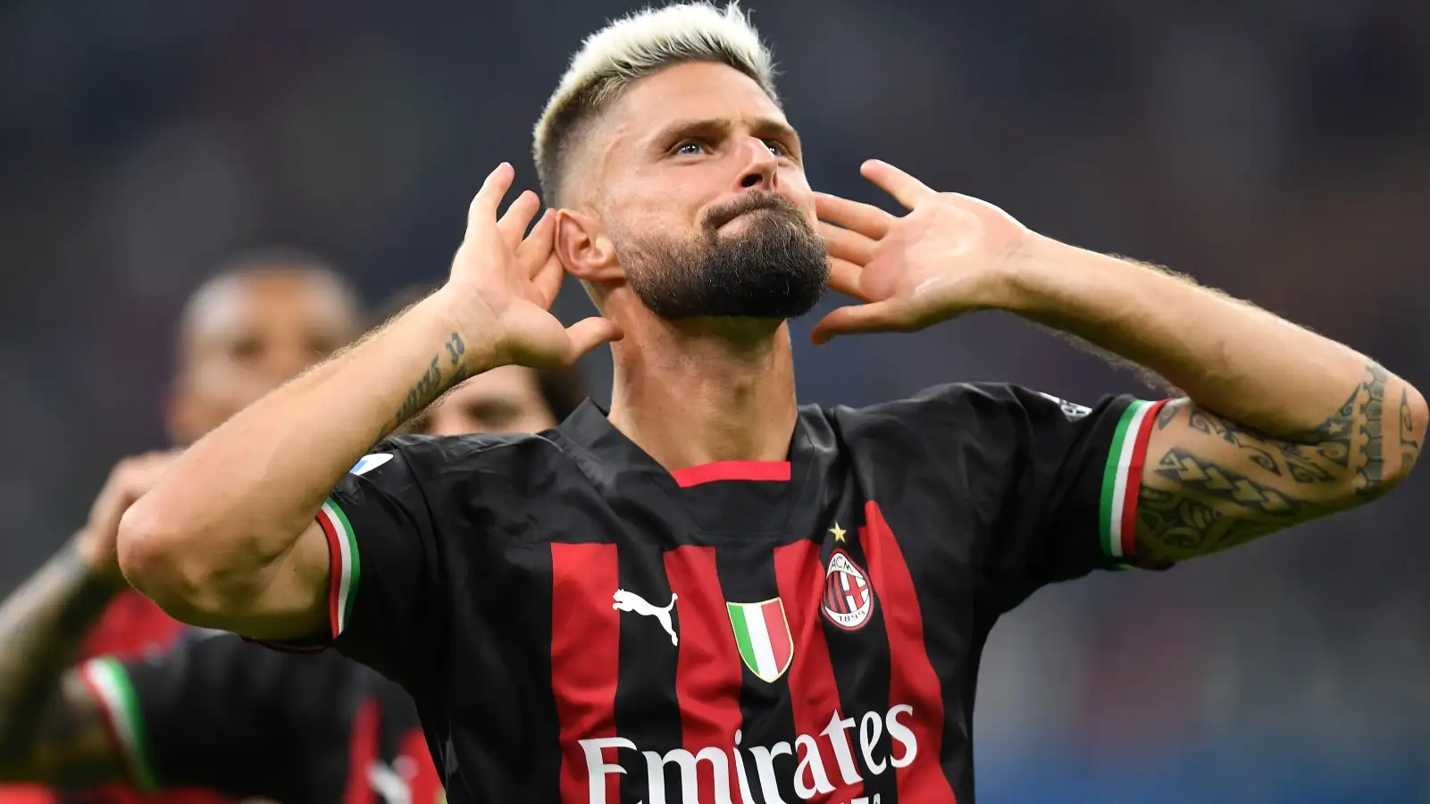 Olivier Giroud celebrates scoring for AC Milan.