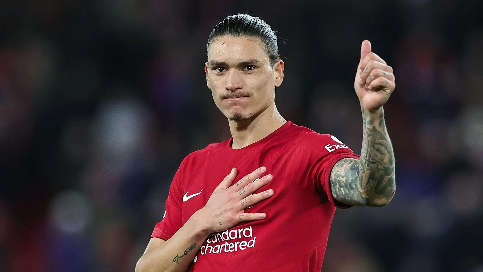 Darwin Núñez #27 of Liverpool touches the badge on his shirt and gives the thumbs up to the fans at the end of the Premier League match Liverpool vs Leicester City at Anfield, Liverpool, United Kingdom, 30th December 2022