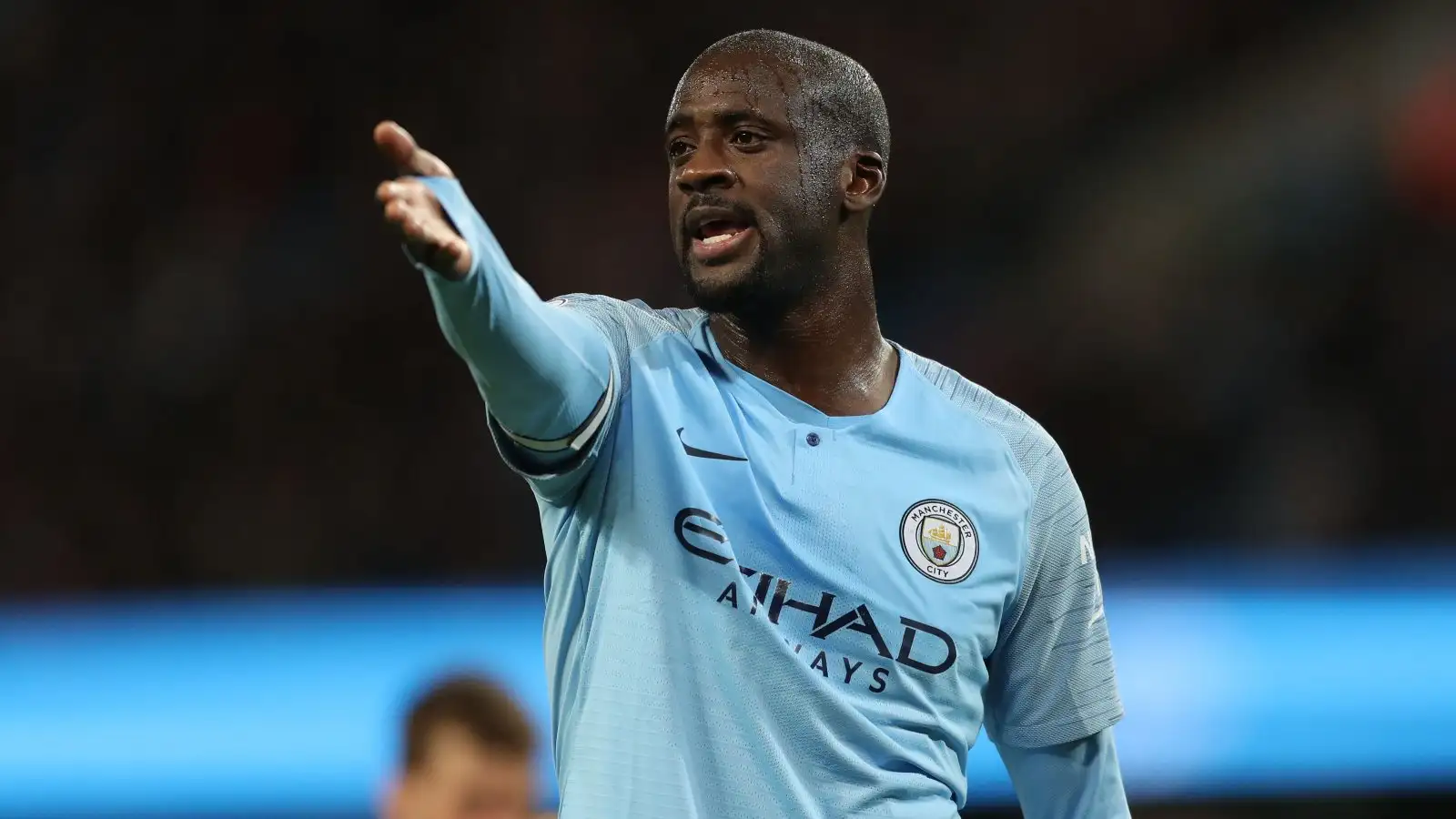 Man City midfielder Yaya Toure points instructions to his team-mates