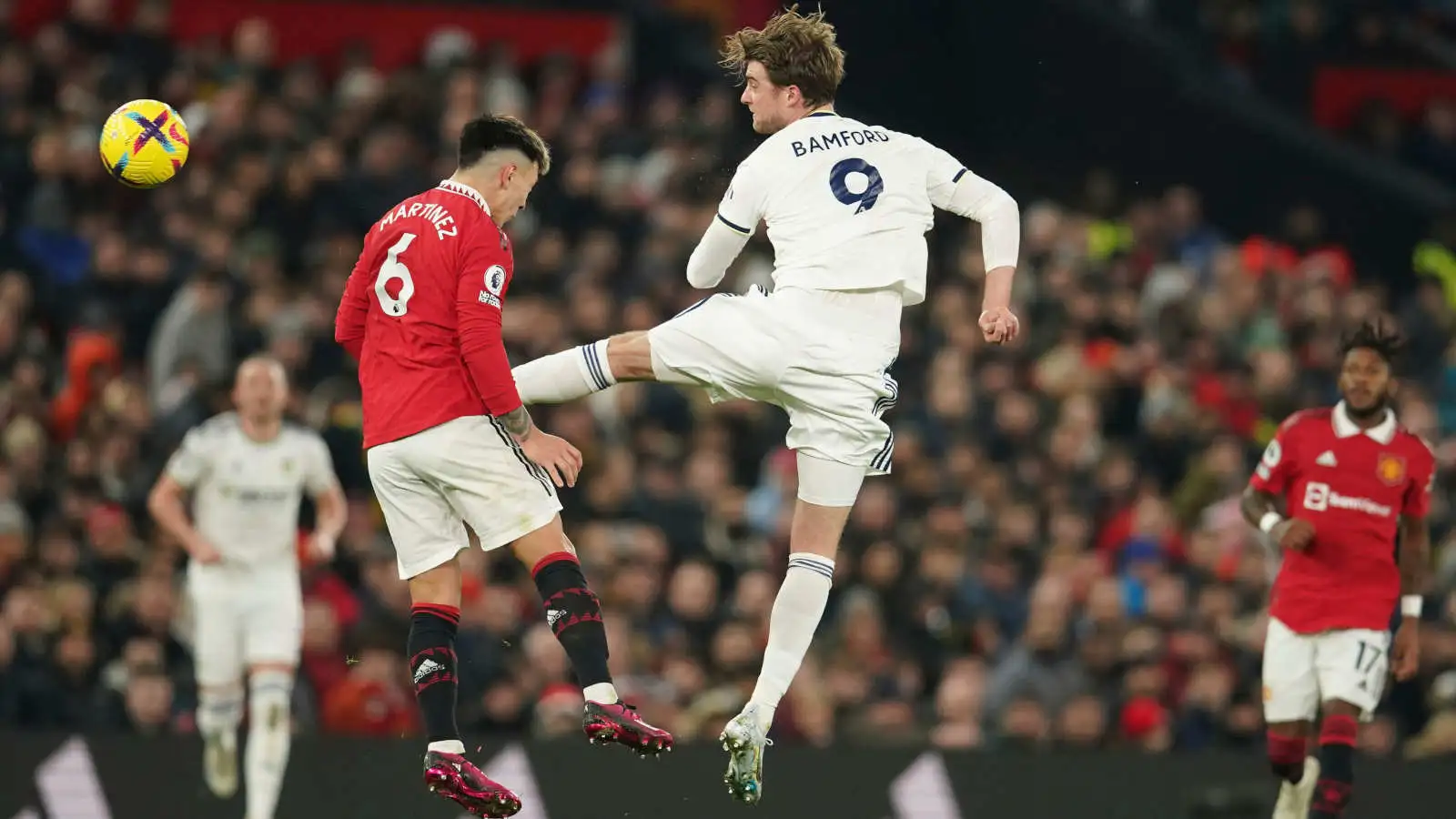Lisandro Martinez and Patrick Bamfford challenge for the ball during the Premier League match between Manchester United and Leeds United