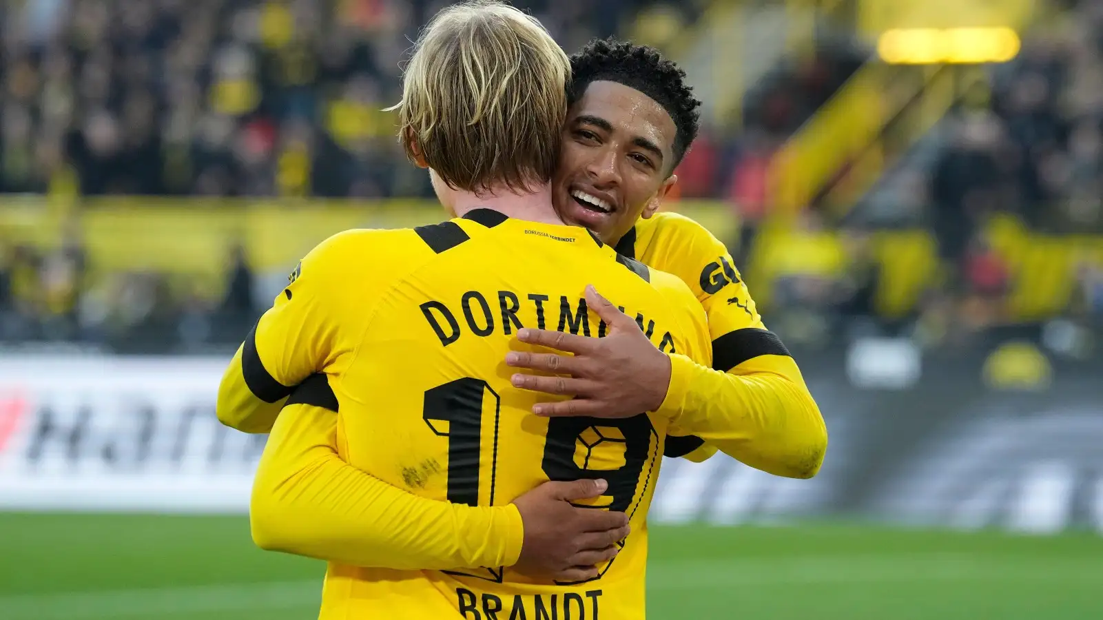 Jude Bellingham and Julian Brandt celebrate after a Borussia Dortmund goal.