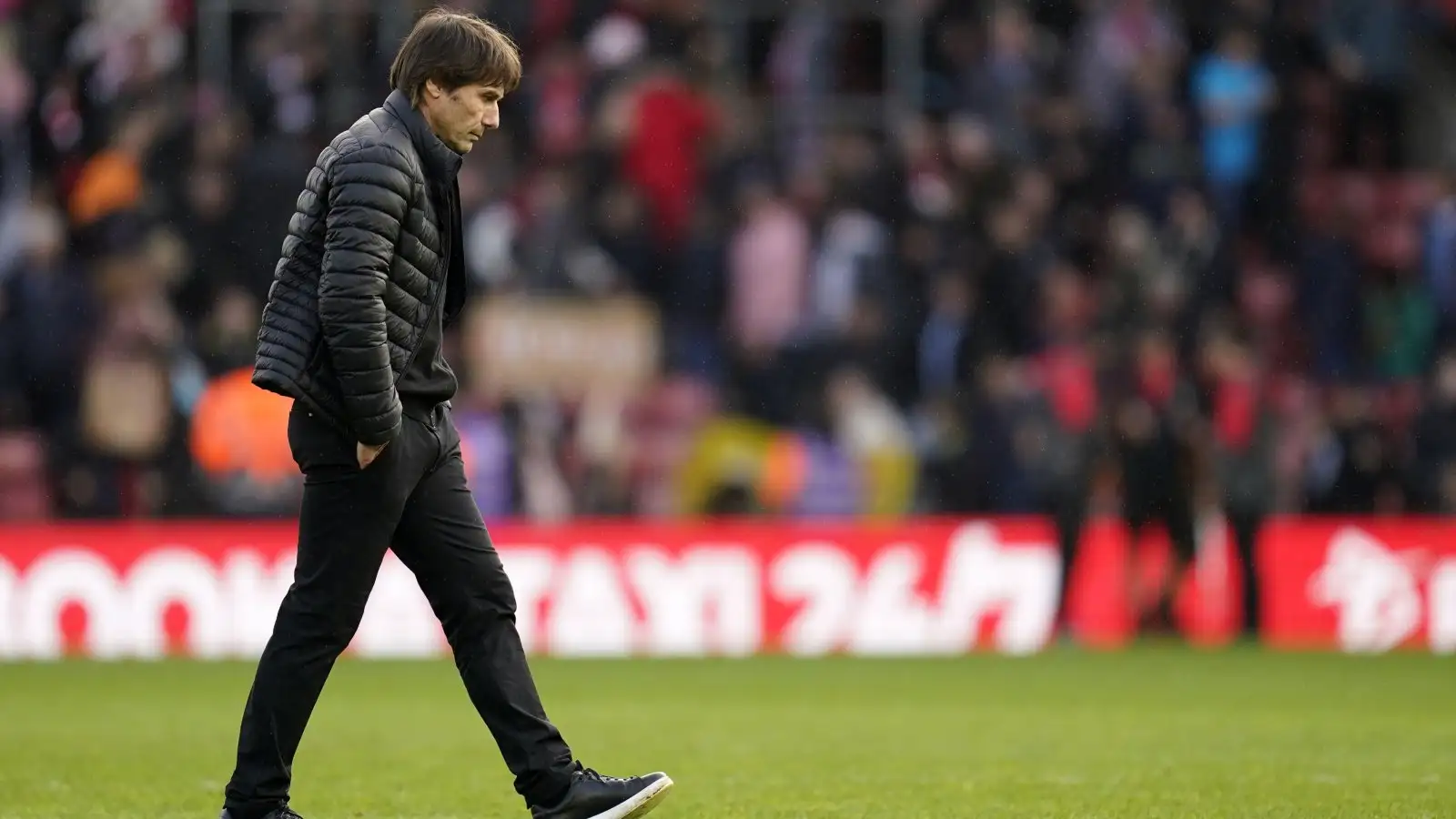 Tottenham boss Antonio Conte looks dejected as he walks across the pitch