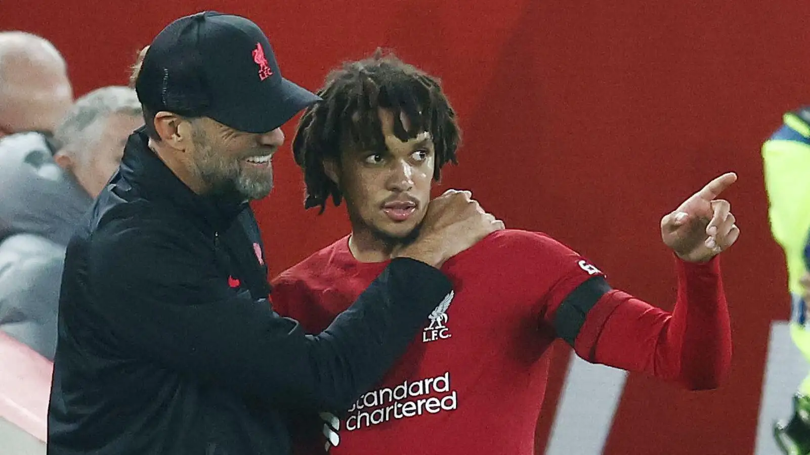 Liverpool manager Jurgen Klopp talks to Trent Alexander-Arnold on the touchline at Anfield.
