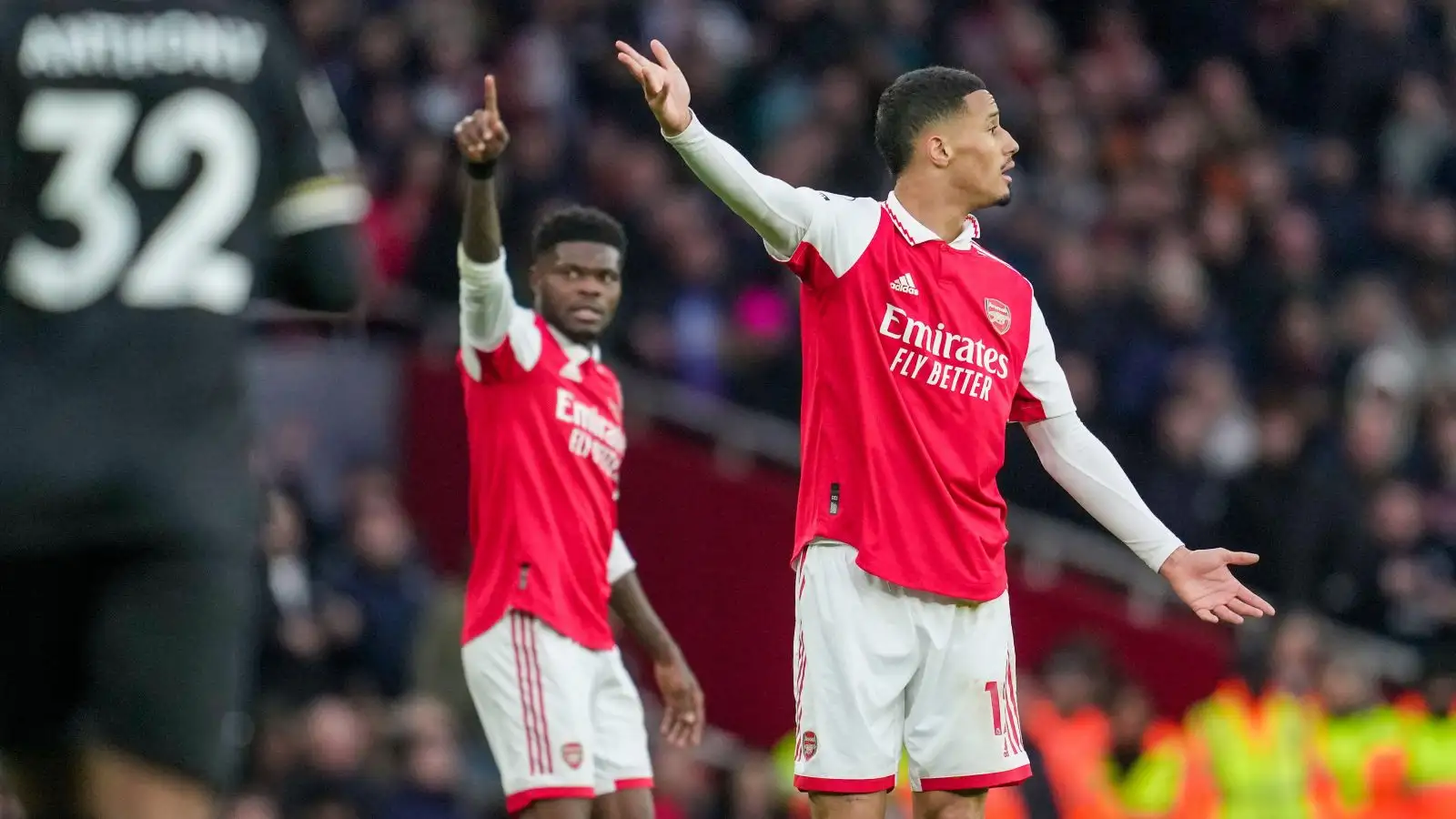 Arsenal duo William Saliba and Thomas Partey gesture during a match against Bournemouth