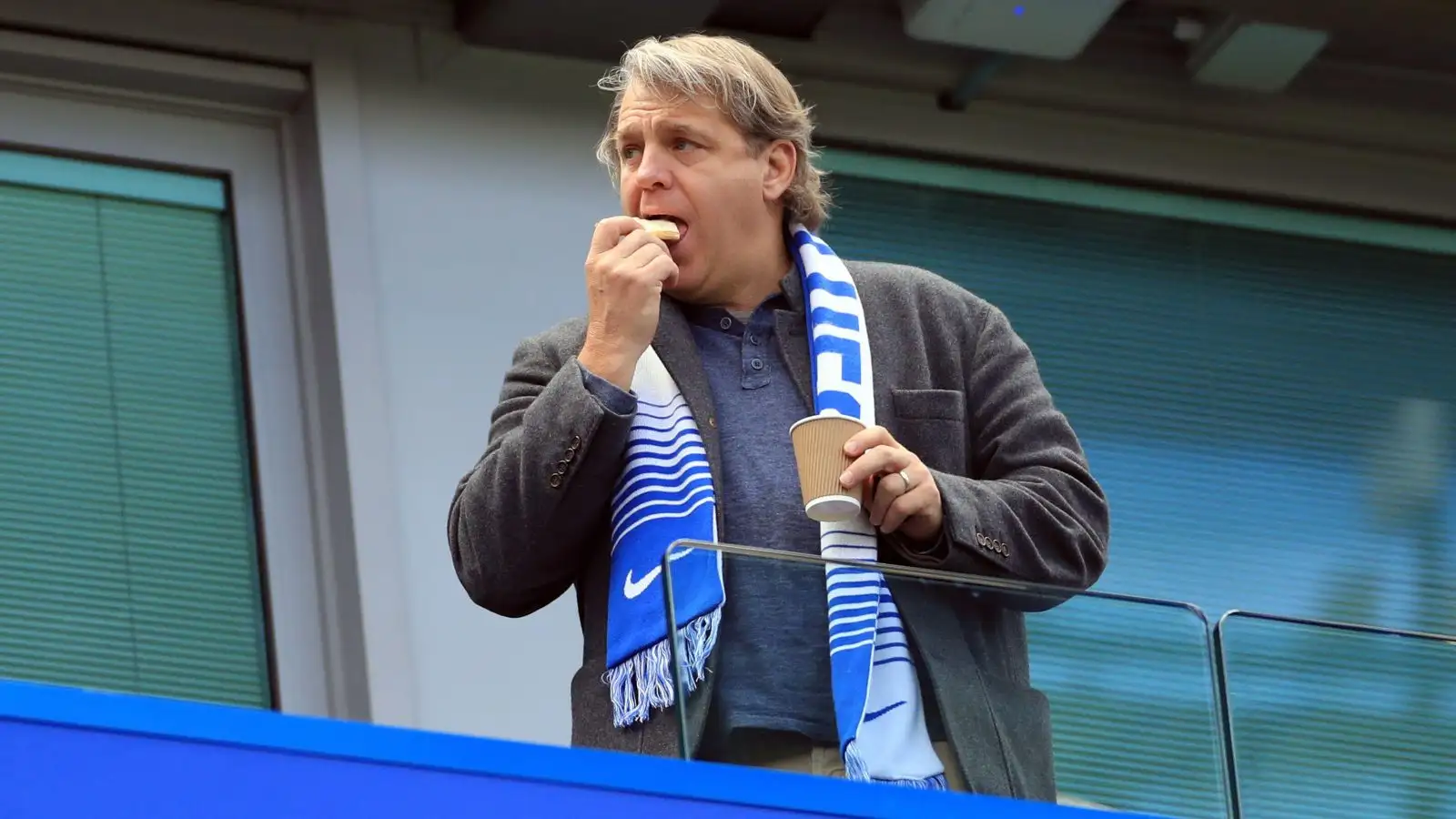 Chelsea owner Todd Boehly eats a biscuit