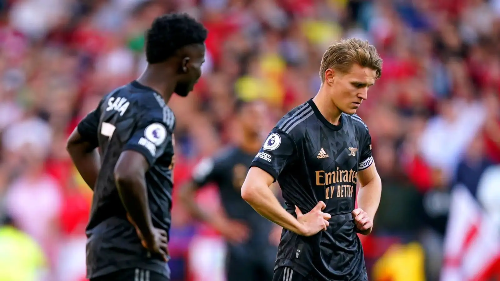 Arsenal players Bukayo Saka and Martin Odegaard appear dejected
