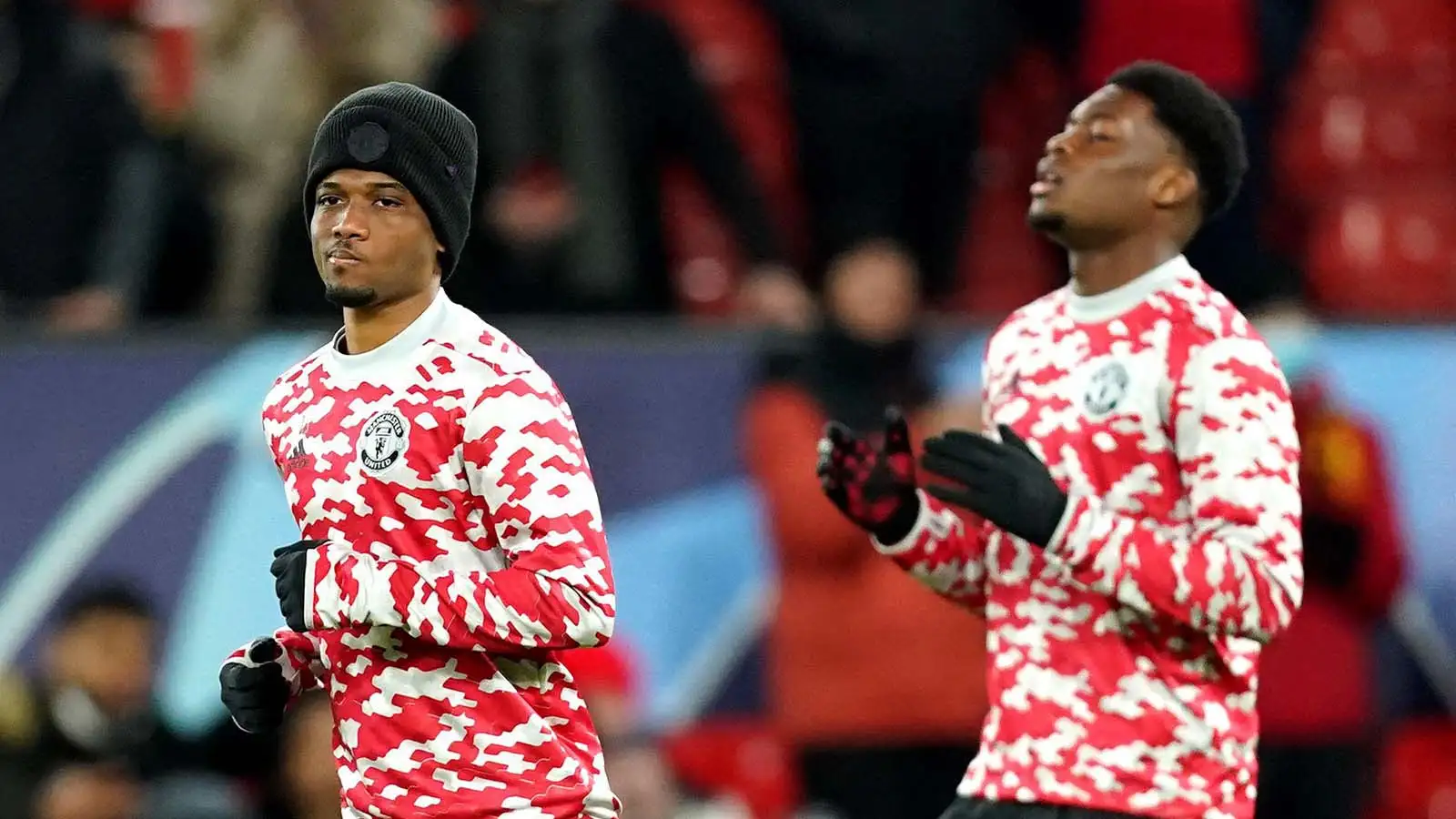 Manchester United's Amad Diallo (left) and Teden Mengi warm up for the UEFA Champions League, Group F match at Old Trafford