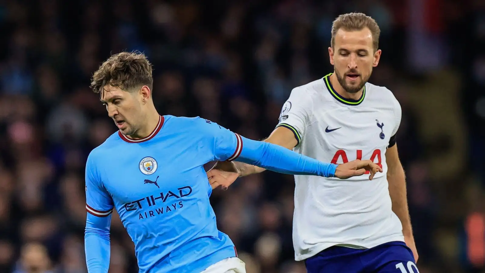 Manchester City defender John Stones holds off Harry Kane