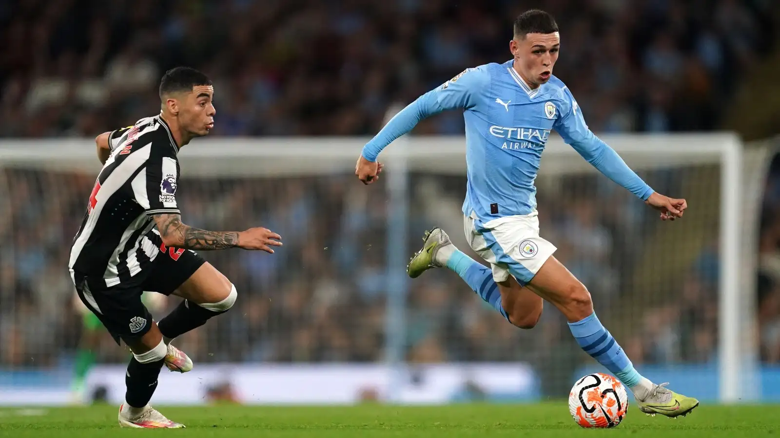 Man City's Phil Foden dribbles past Newcastle winger Miguel Almiron.