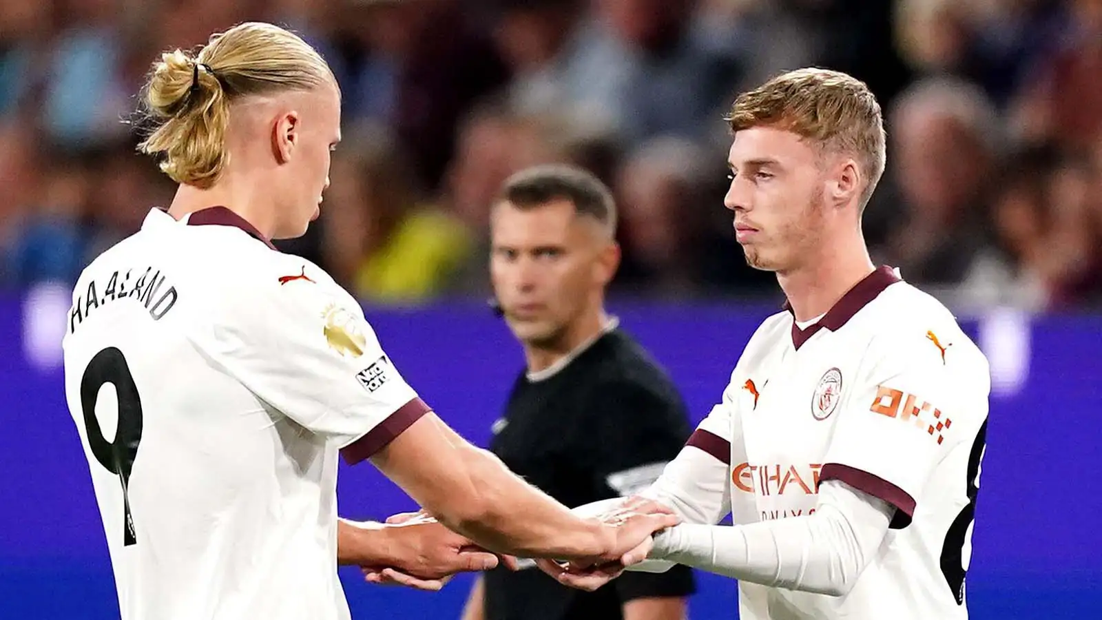 Manchester City's Erling Haaland (left) is substituted off for team-mate Cole Palmer