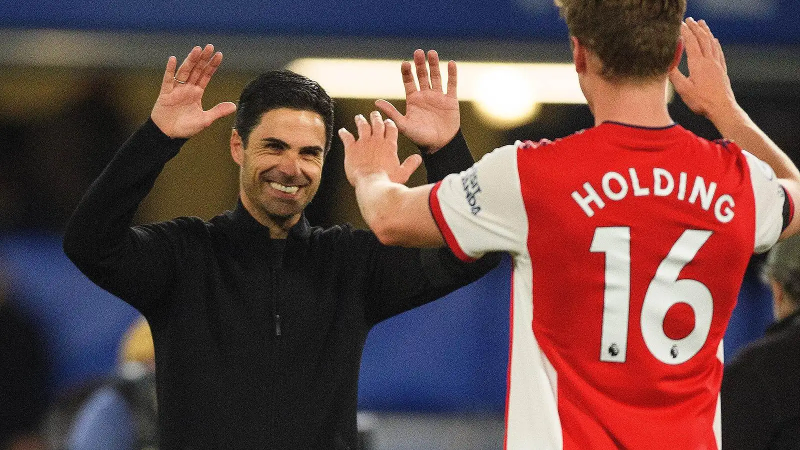 Mikel Arteta celebrates a win against Chelsea with Rob Holding.