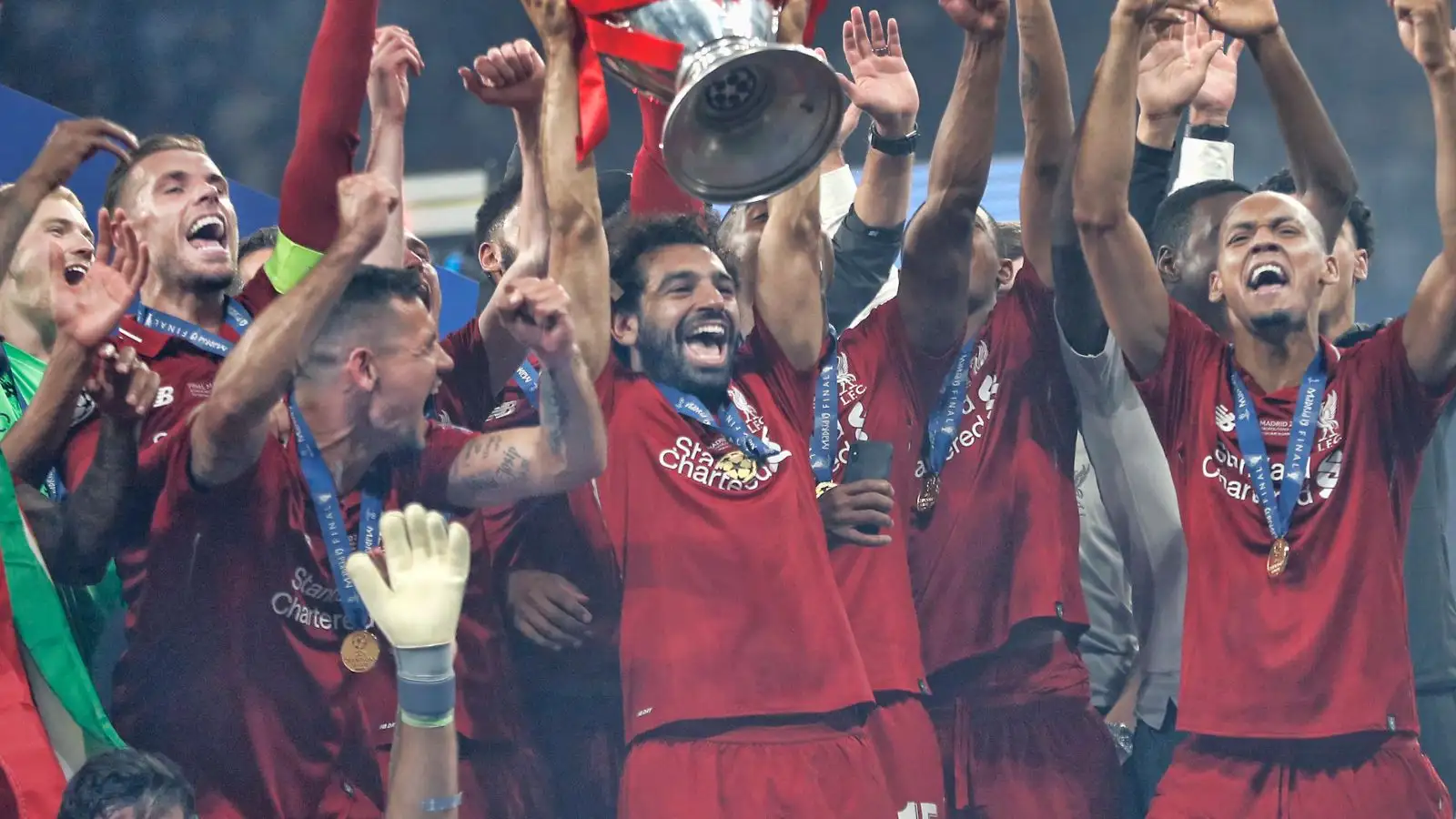 Liverpool players celebrate with the Champions League trophy