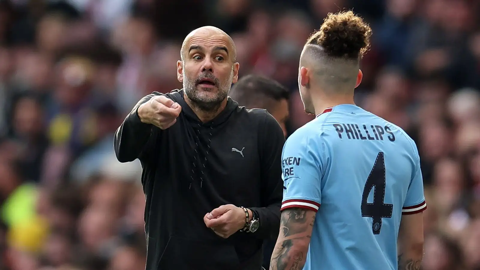 Manchester City manager Pep Guardiola gives instructions to Kalvin Phillips.
