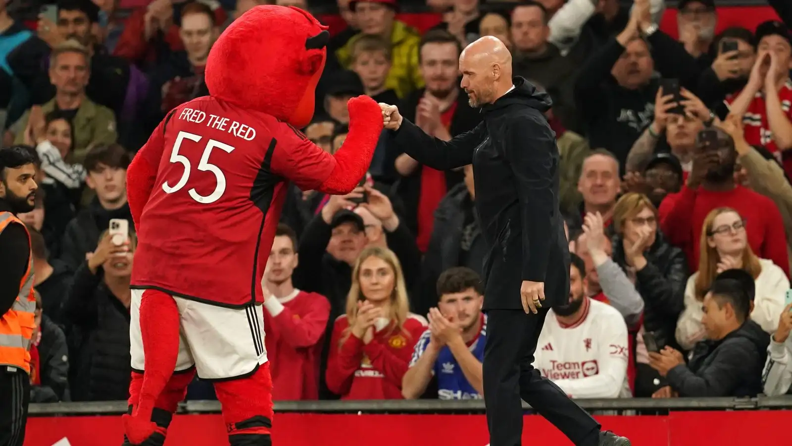 Erik ten Hag bumps fists with Manchester United mascot Fred the Red.