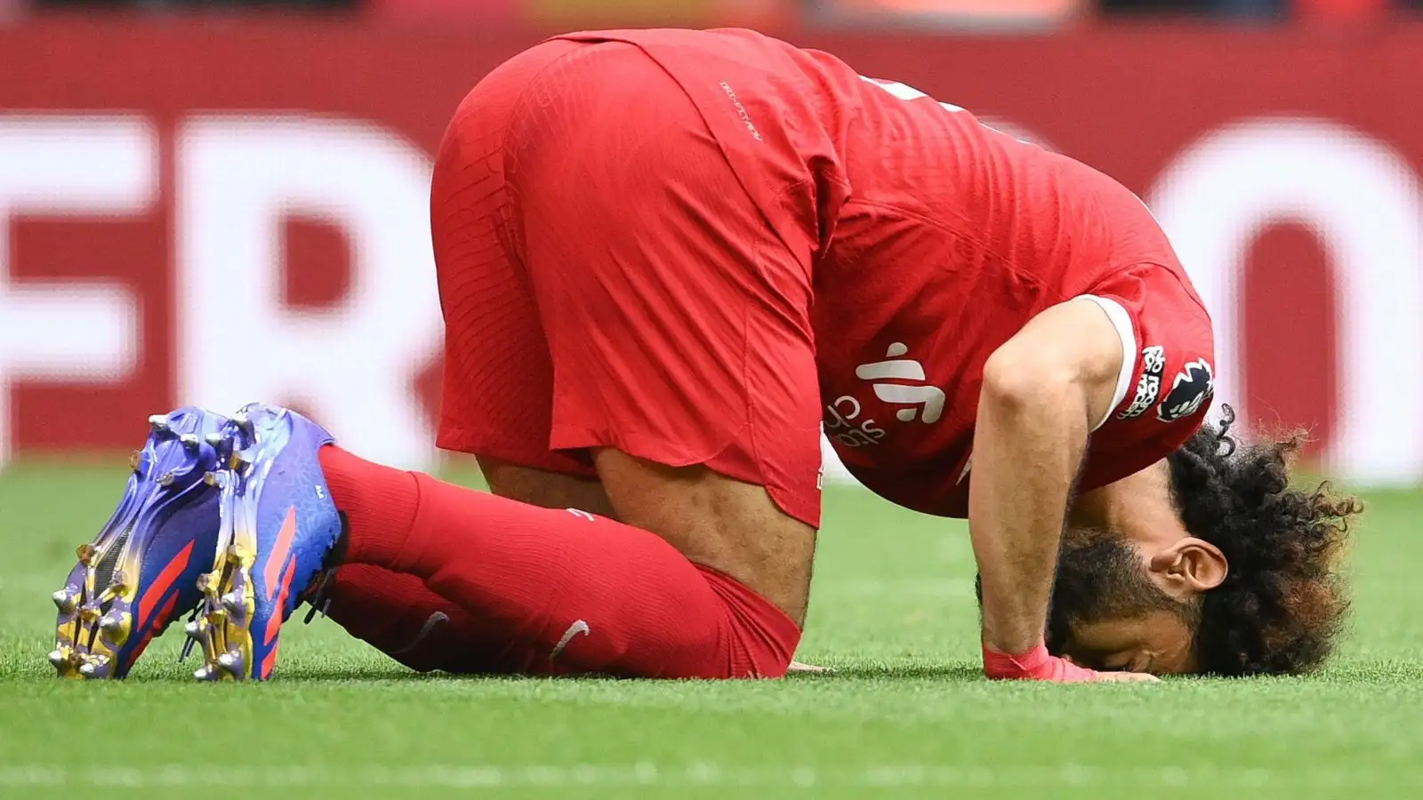 Liverpool forward Mo Salah on his knees