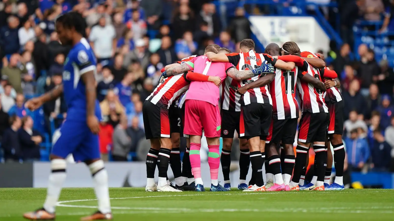 Brentford players huddle before their Premier League match at Chelsea.