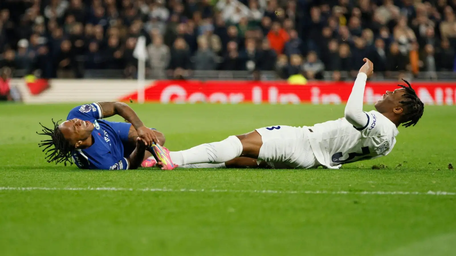 Tottenham defender Fate Udogie fouls Raheem Sterling