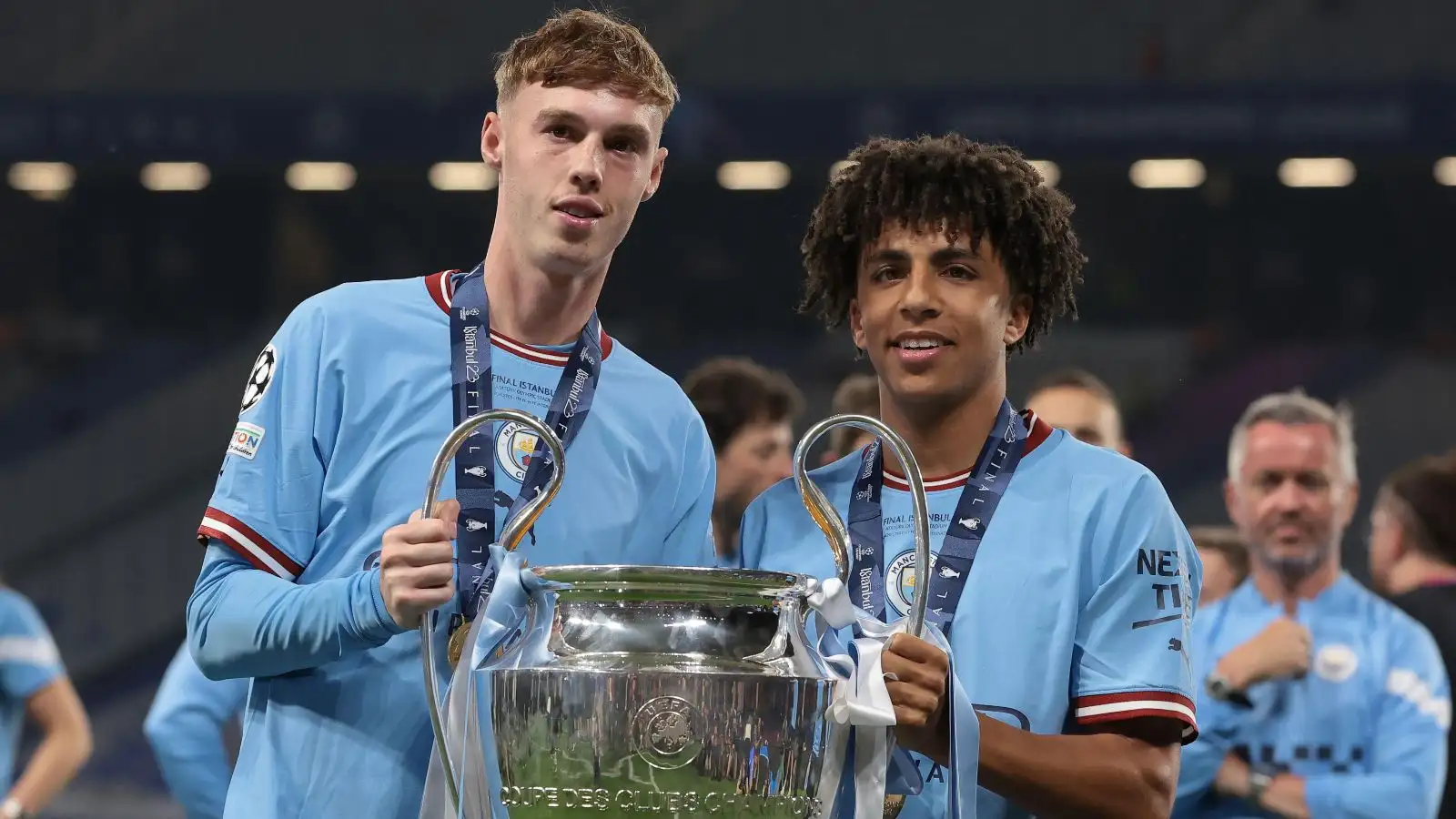 Manchester Municipal sons Cole Palmer and also Rico Lewis hold the Champions League trophy.