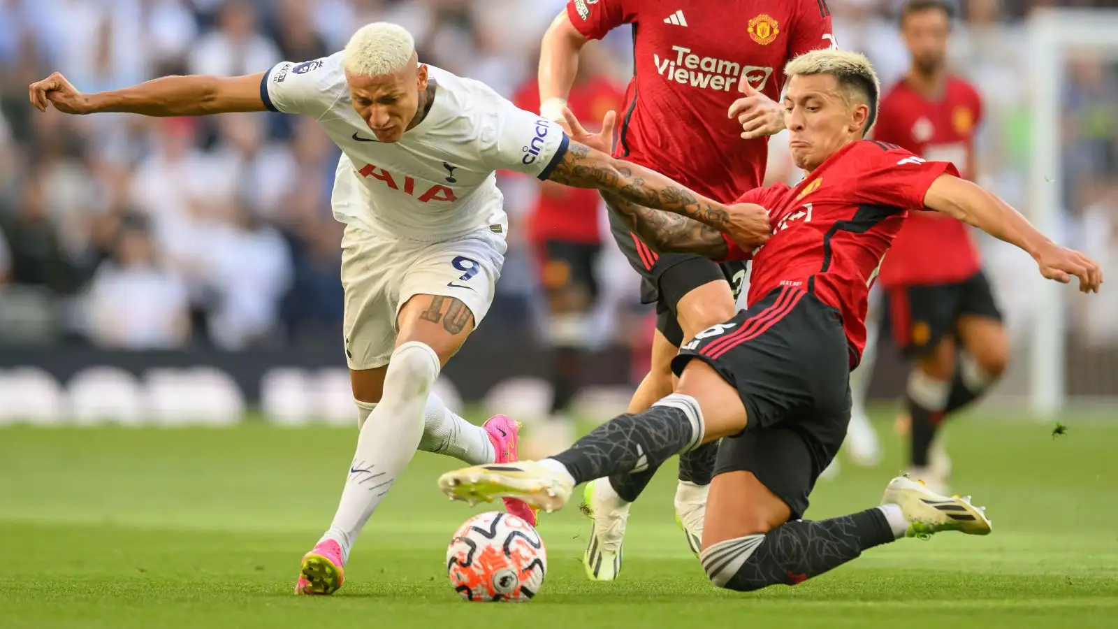 Spurs striker Richarlison is tackled by Manchester United defender Lisandro Martinez