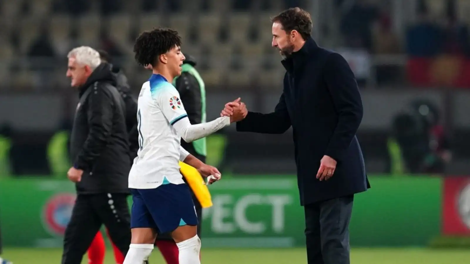 England defender Rico Lewis shakes hands with Gareth Southgate.