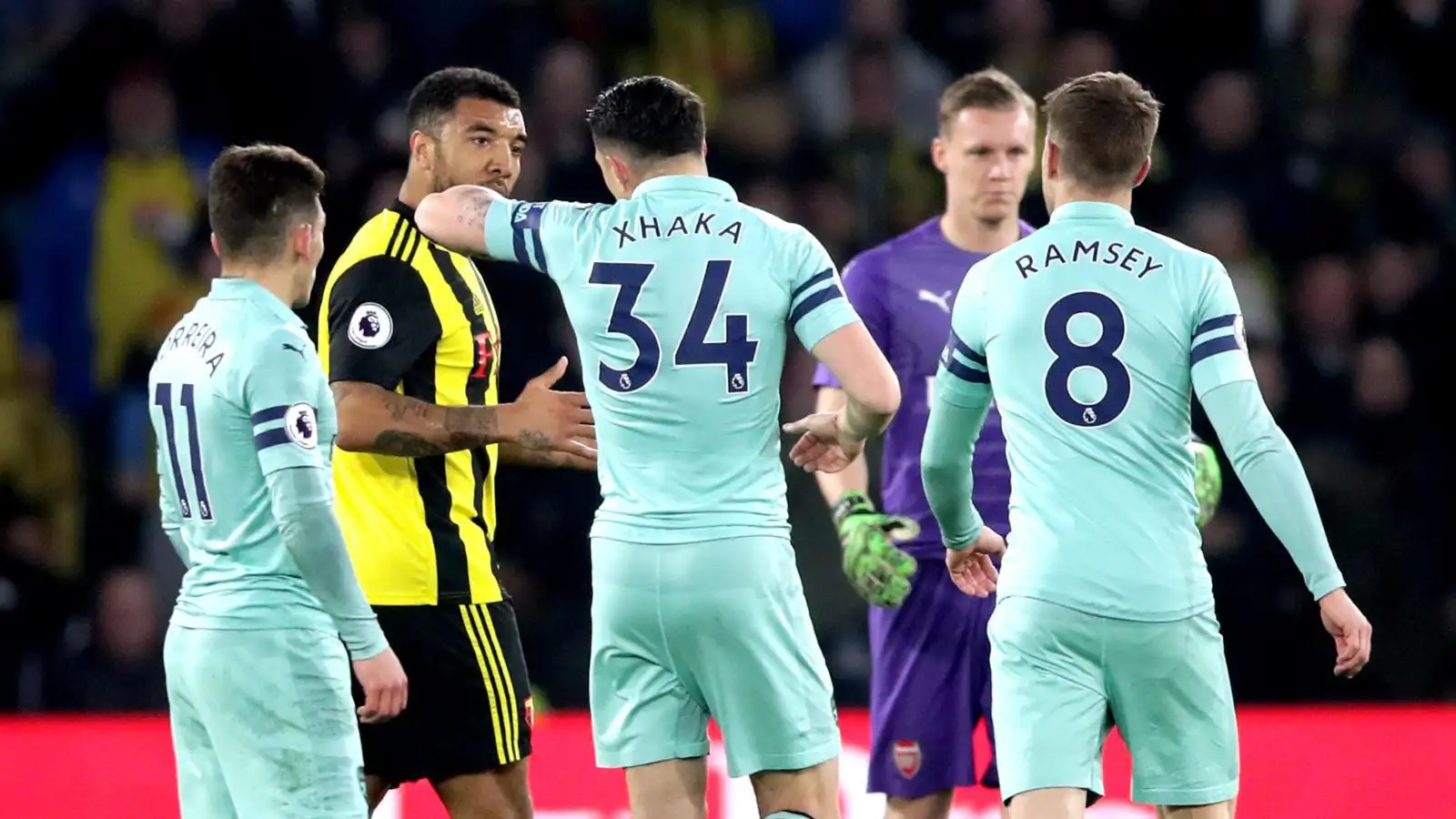 Troy Deeney argues with Arsenal players
