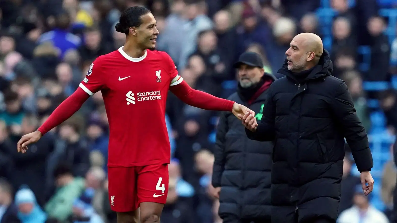 Liverpool defender Virgil van Dijk talks to Manchester City manager Pep Guardiola