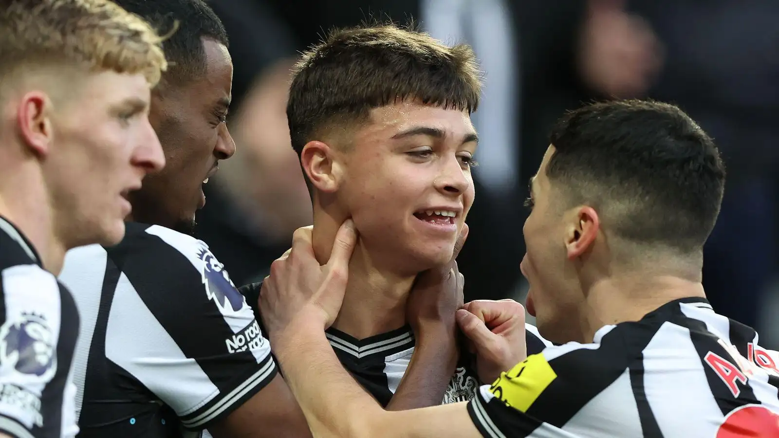 Newcastle players celebrate with Lewis Miley