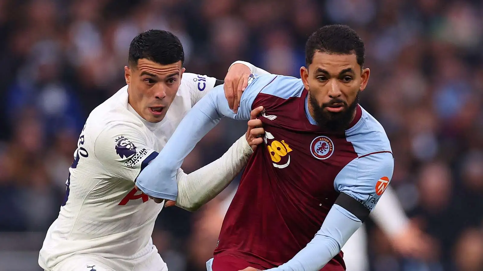 Douglas Luiz of Aston Villa is under pressure from Pedro Porro of Tottenham Hotspur