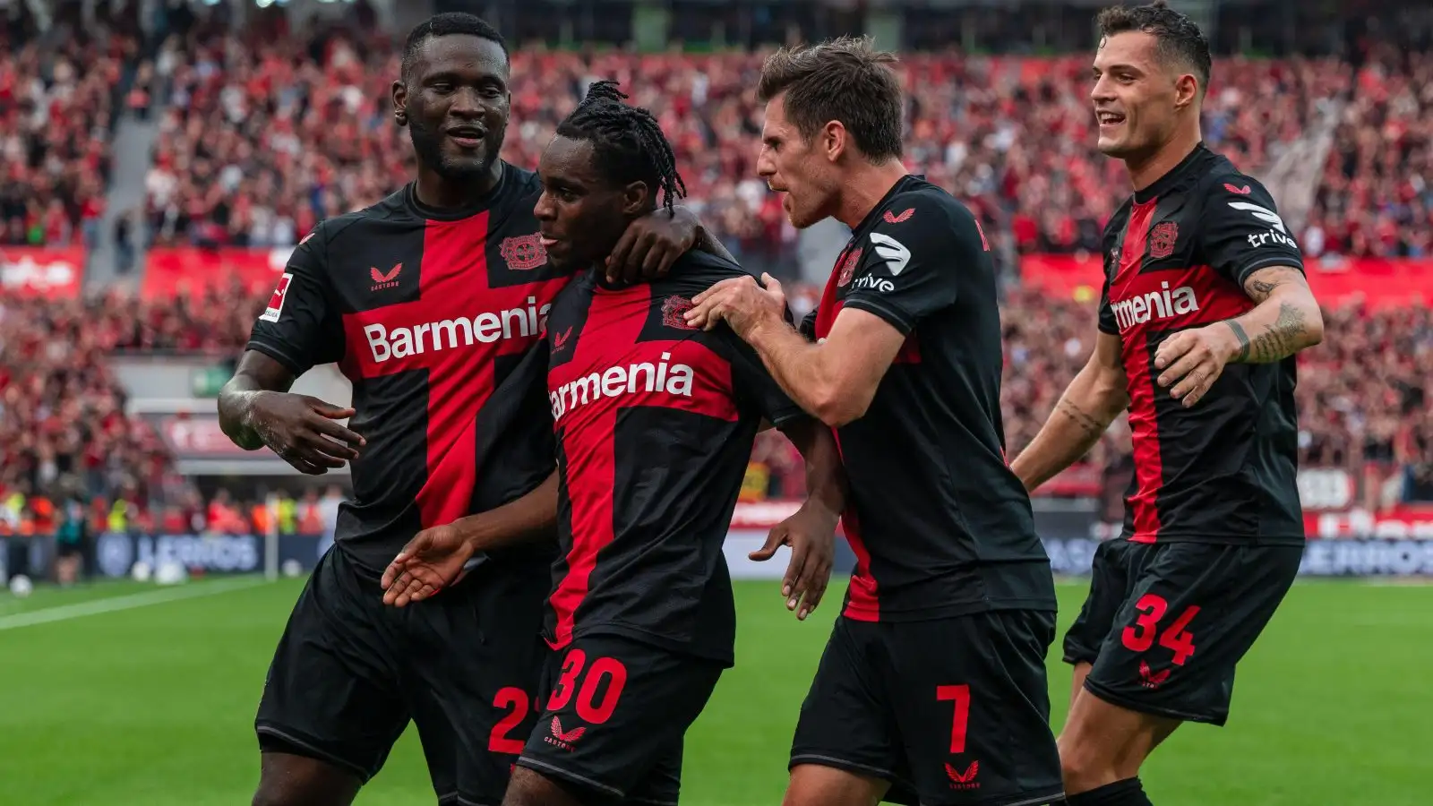 Bayer Leverkusen wing-back Jeremie Frimpong celebrates his goal with his teammates.