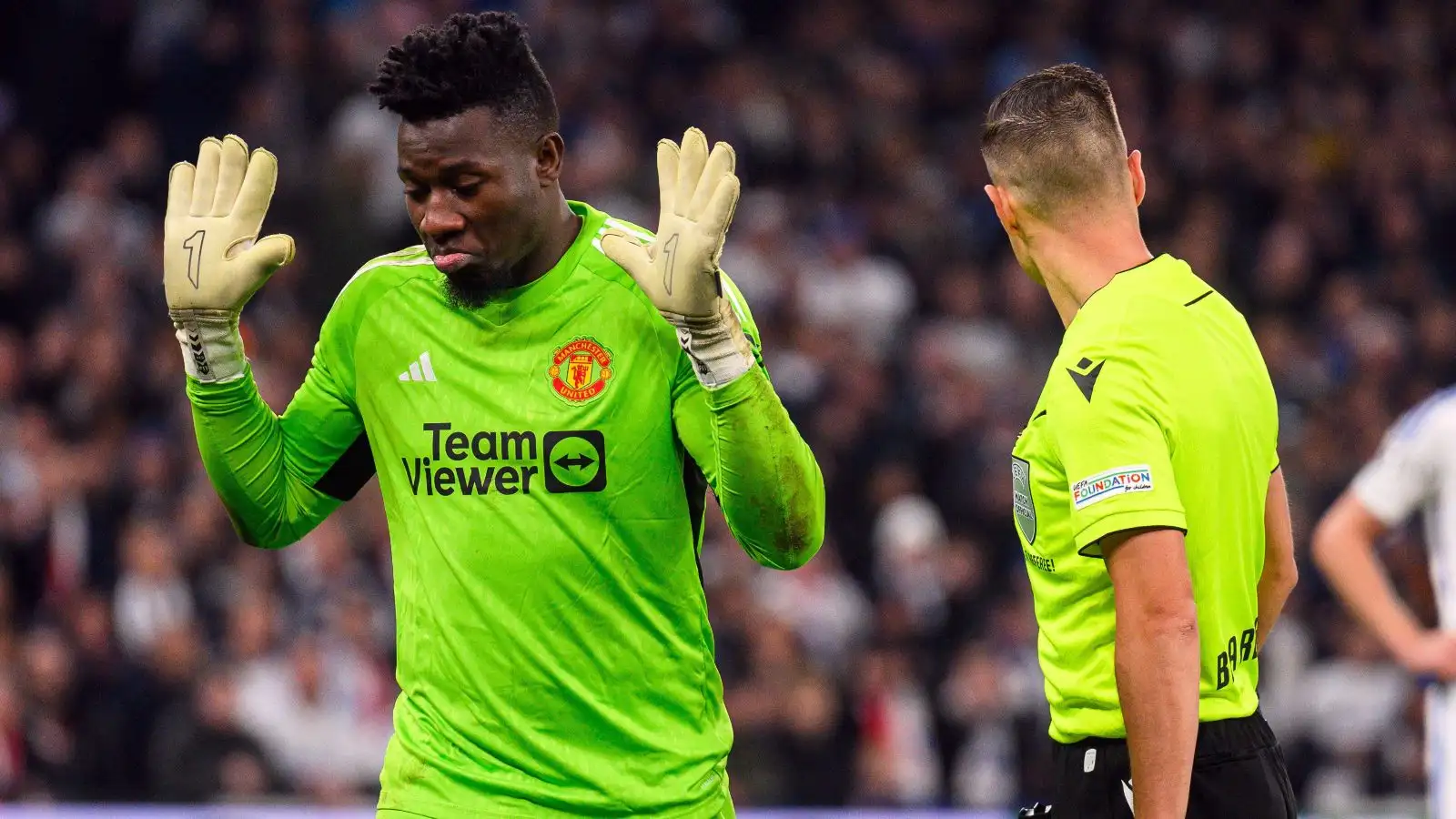 Andre Onana holds his hands upward throughout a game.